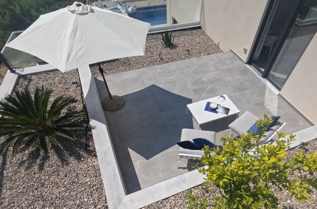 Villa Fay terrace with a table and chairs and umbrellas
