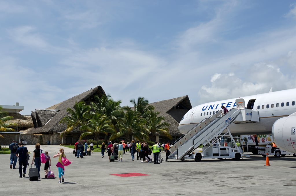 Travelers arriving at Punta Cana Airport in the Dominican Republic from a United Airlines plane