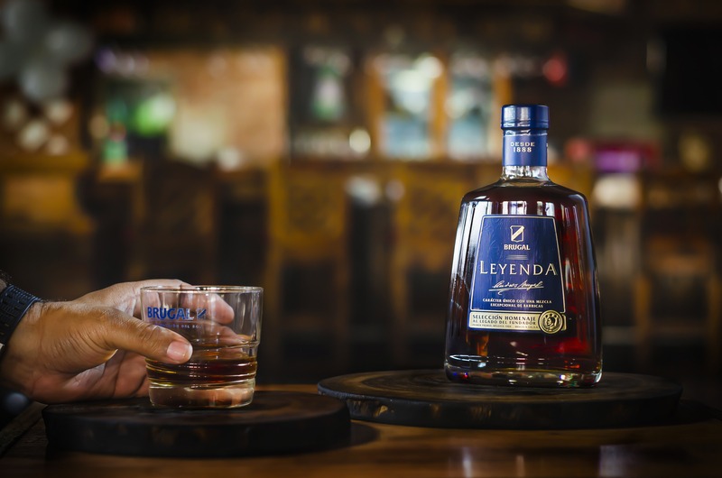 Brugal Leyenda aged Dominican rum served neat in a glass at a bar