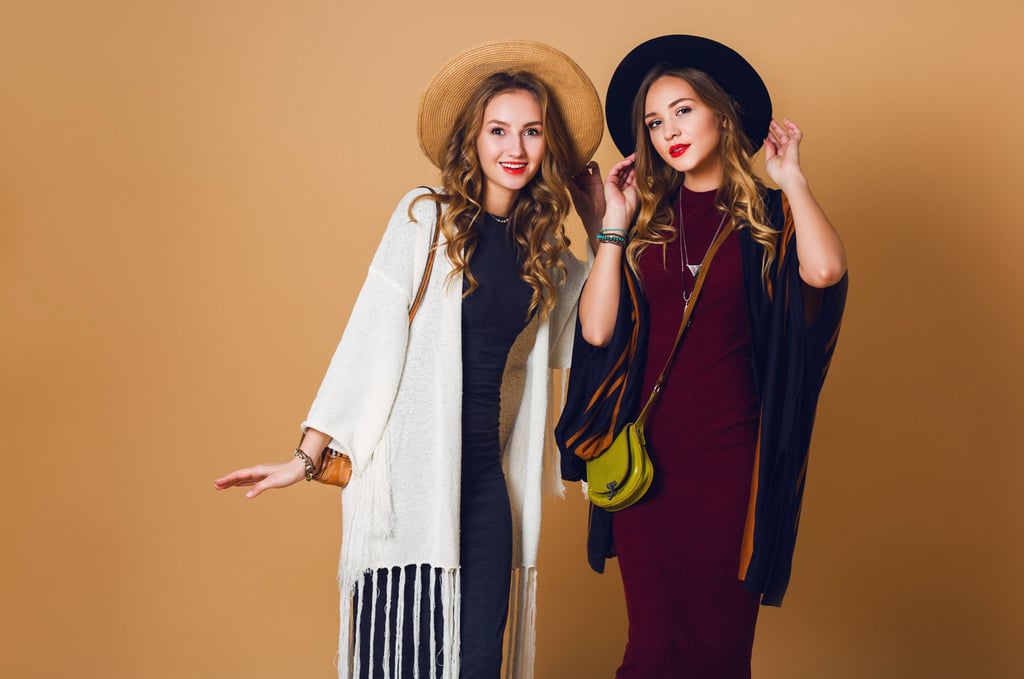 groomed-personality-girls-standing-with-hats-and-bags