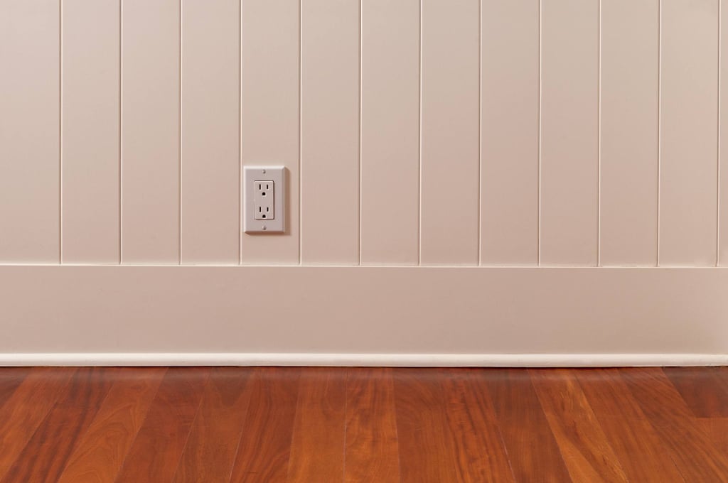 Baseboard trim covering the edge gap between wall and flooring.