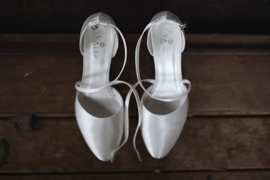 a bride's pair of white wedding shoes