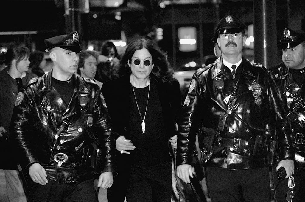 Ozzy Osbourne, flanked by Philadelphia police officers, leaves Borders in Center City after signing 