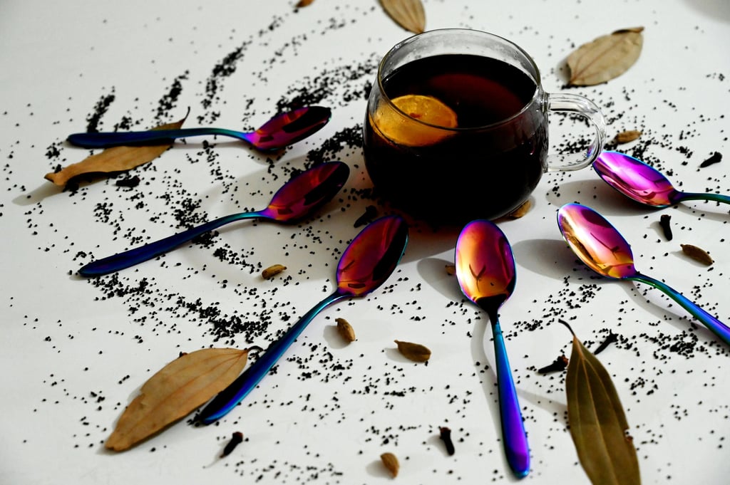 a cup of tea with spoons and spoons on a table
