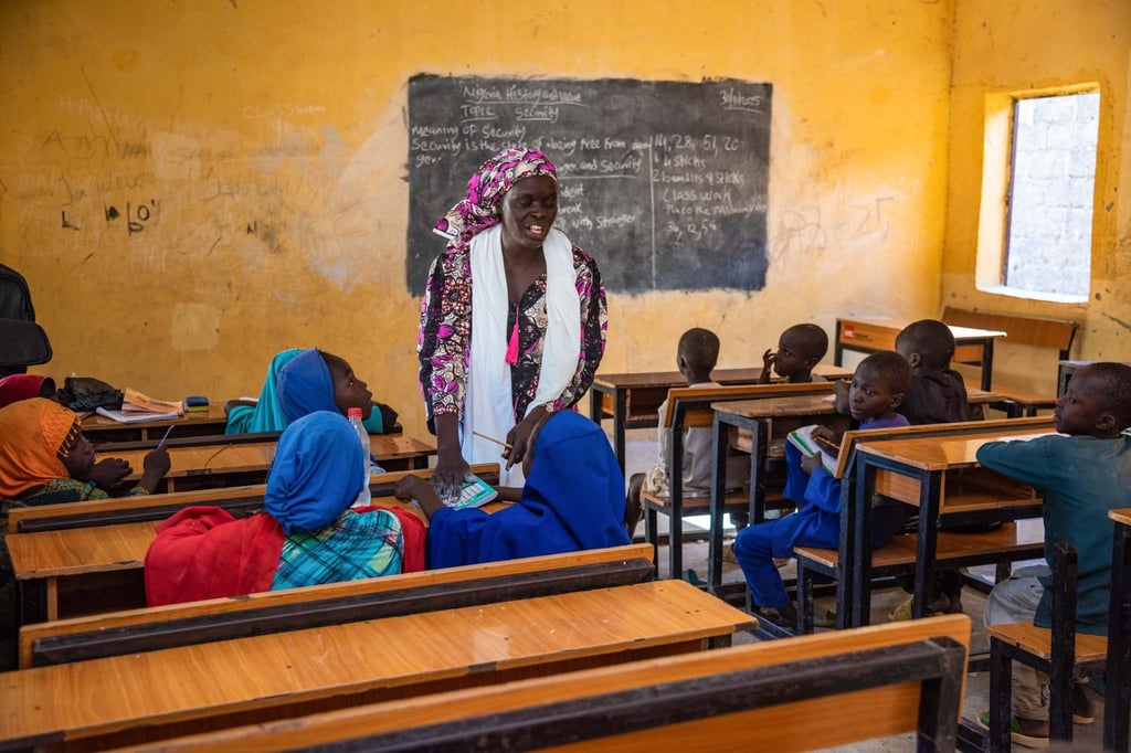 Rebecca in a classroom full of ABEP learners