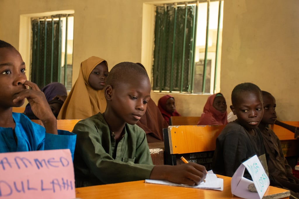 Musa, 11, Gwoza, Nigeria. The image shows Musa in class writin