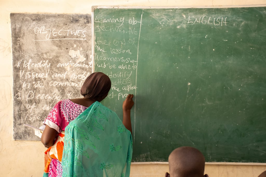 Rebecca standing in front of a chalkboard