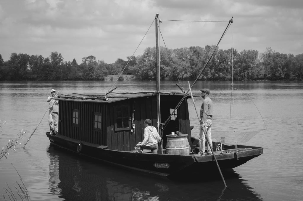 a man standing on a boat in the water