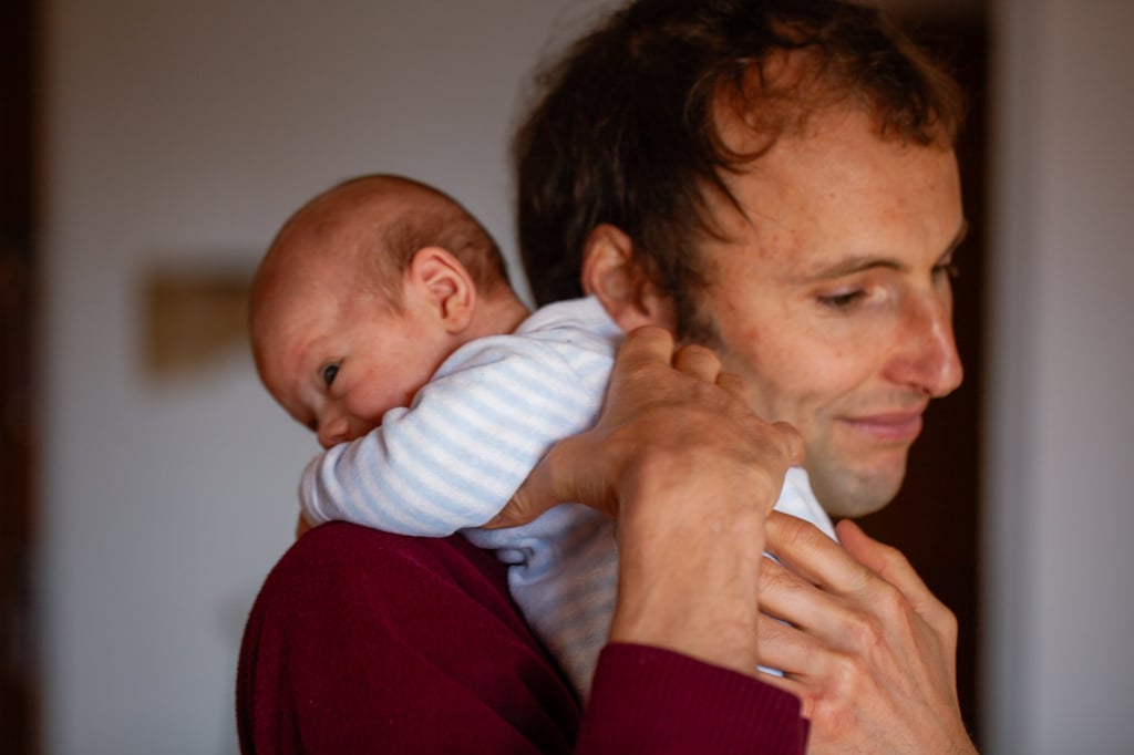 a man holding a baby in his arms