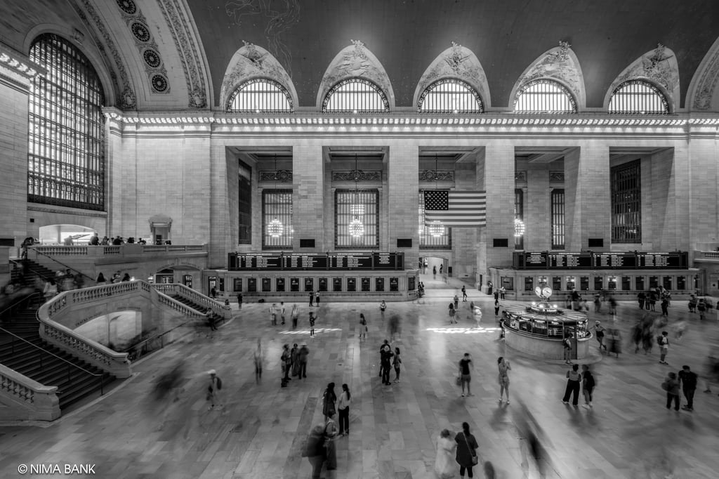 black and white shot of people walking through the grand lobby at grand central terminal in midtown 