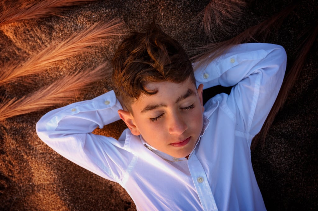 a young boy wearing a white shirt and tie