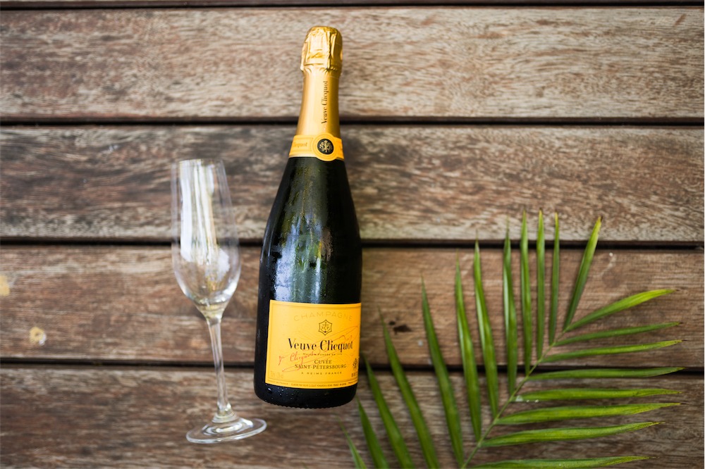 a bottle of champagne in front of a wooden table
