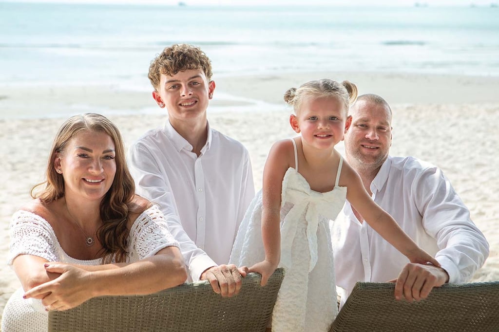 Family posing together on Khem Beach in Phu Quoc