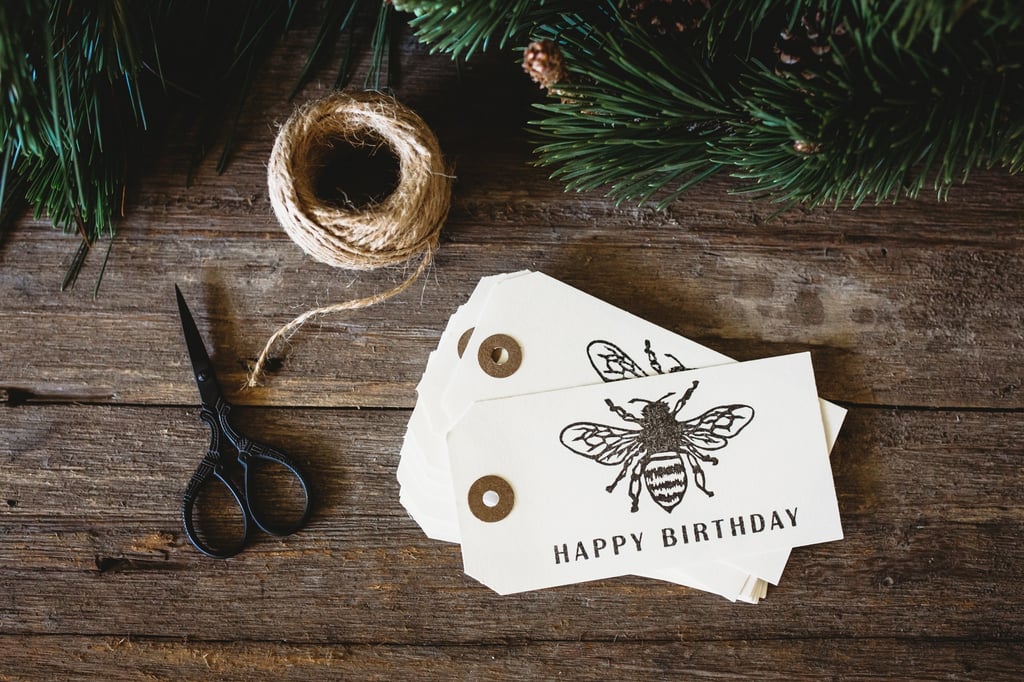 a pair of scissors and a roll of string on a wooden table