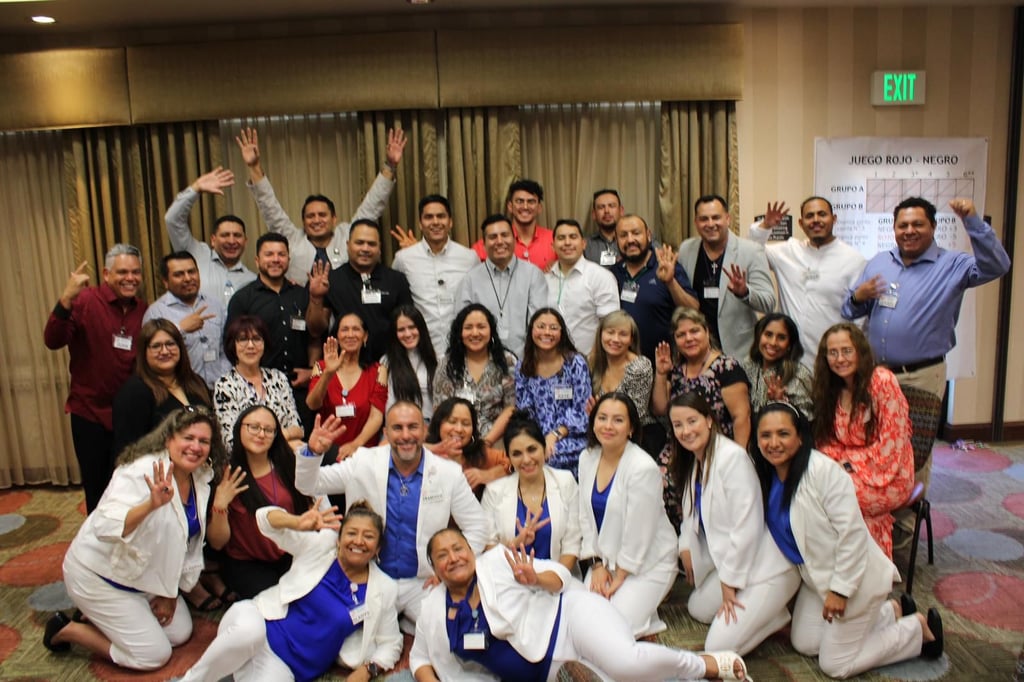 A diverse team of professionals posing for a group photo at a corporate networking event.