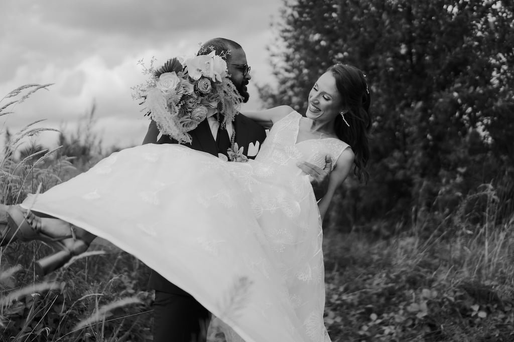 a bride and groom are holding their wedding dress