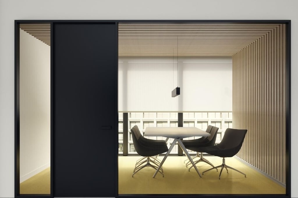 Sala de reuniones moderna con mamparas correderas de cristal y mobiliario minimalista
