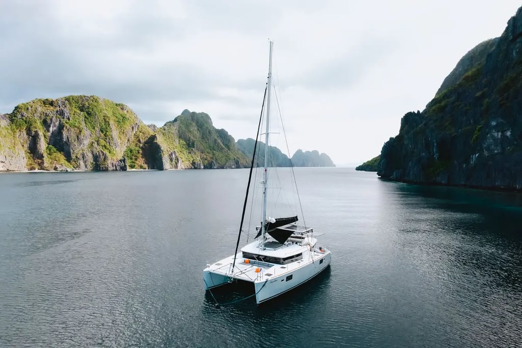 Private luxury yacht cruising through Bacuit Bay, El Nido.