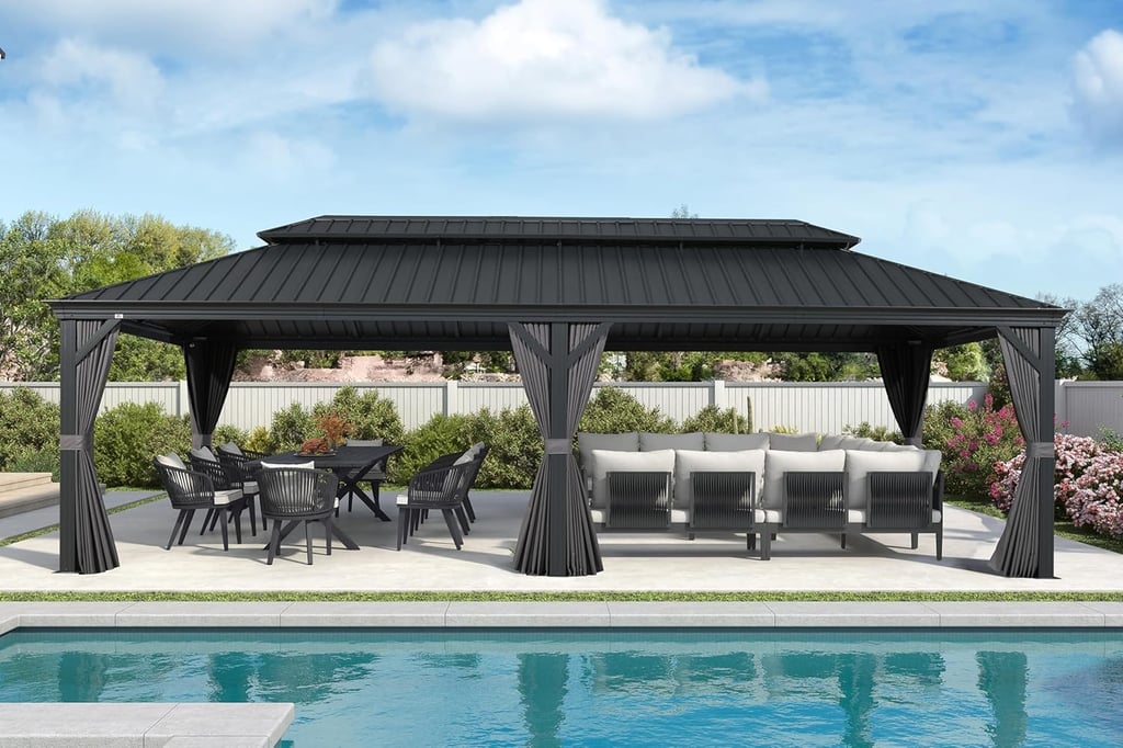 Black hardtop gazebo with outdoor dining set and sectional sofa by a backyard swimming pool.