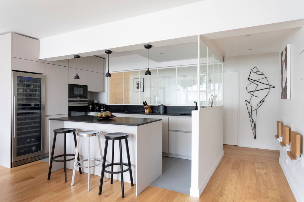 a kitchen with a wine cooler and bar stools