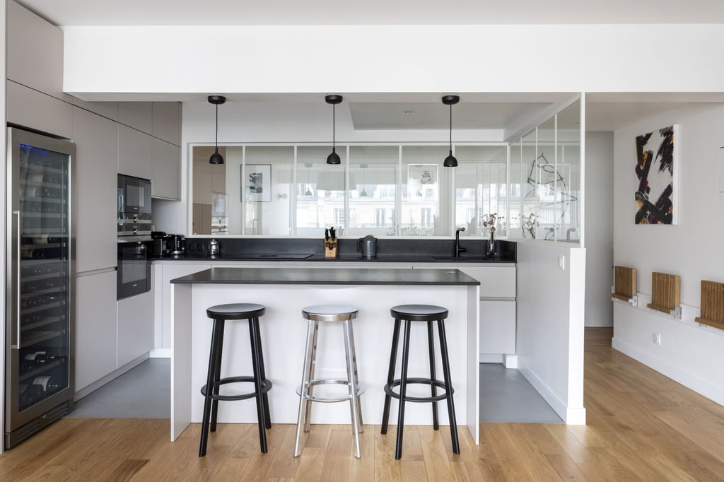 a kitchen with a bar stool and bar stools
