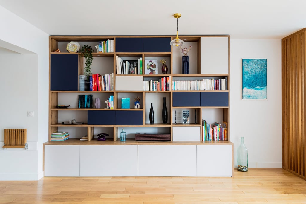 a living room with a bookcase and a wooden floor