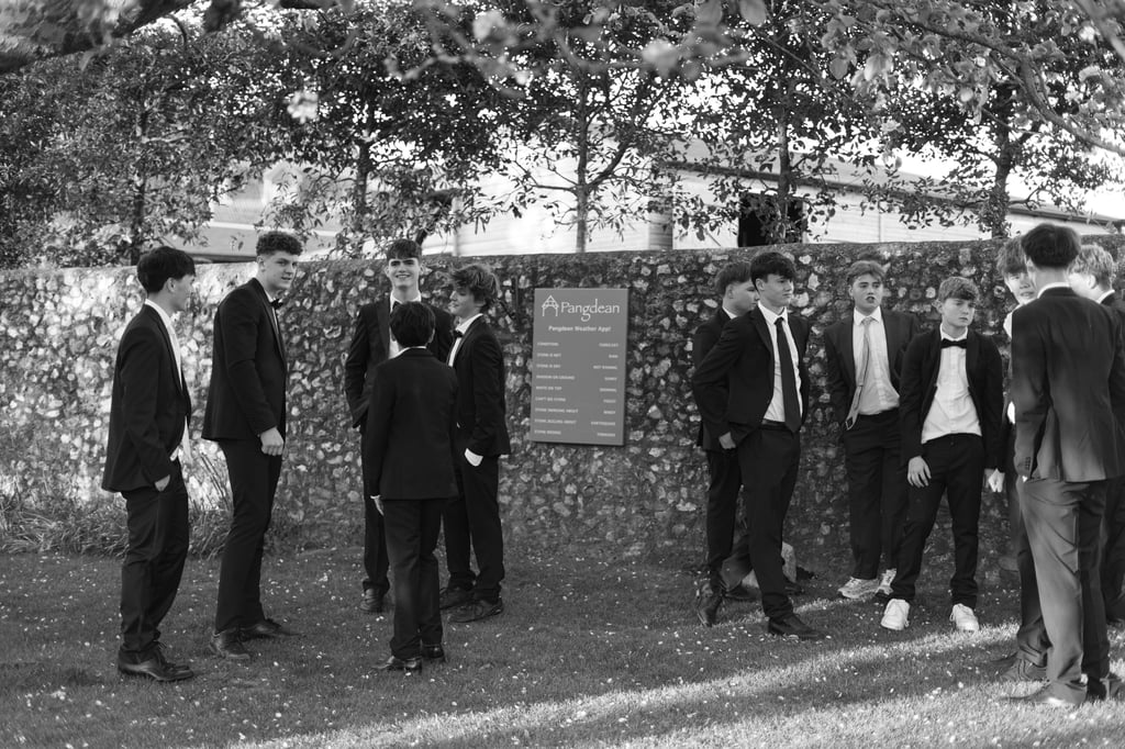 black and white image of boys standing in the park