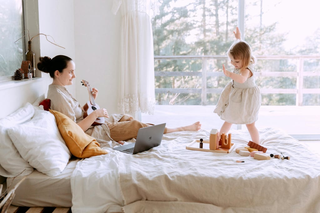 Light-filled bedroom featuring a mother playing a ukulele while her child joyfully dances nearby. Th