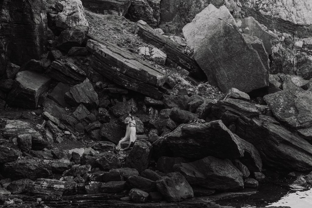 a person standing on a rocky cliff face in Portovenere