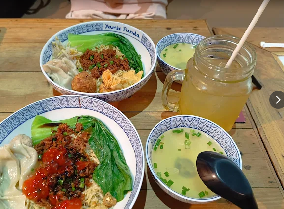 a table with bowls of food and drinks