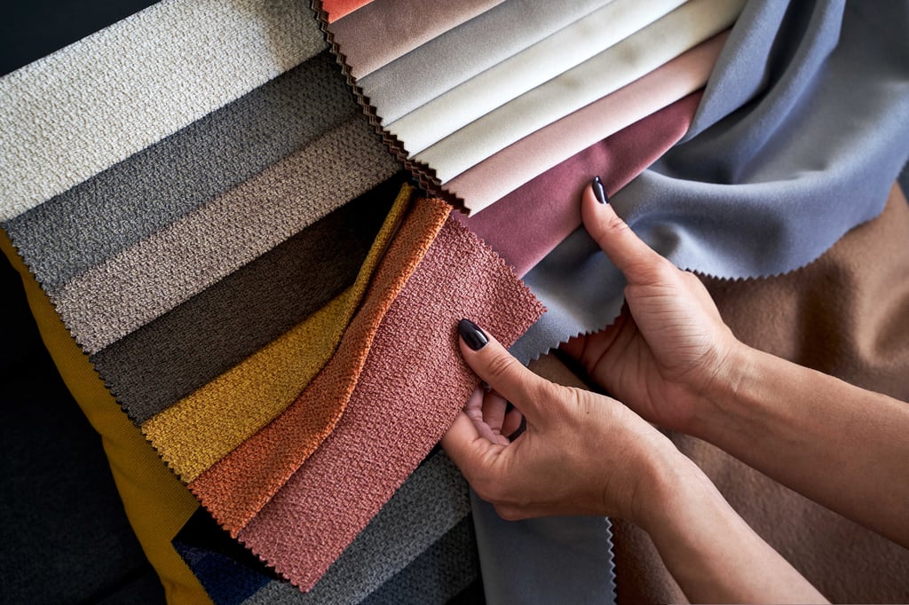 Interior designer Hands checking the quality of textile samples