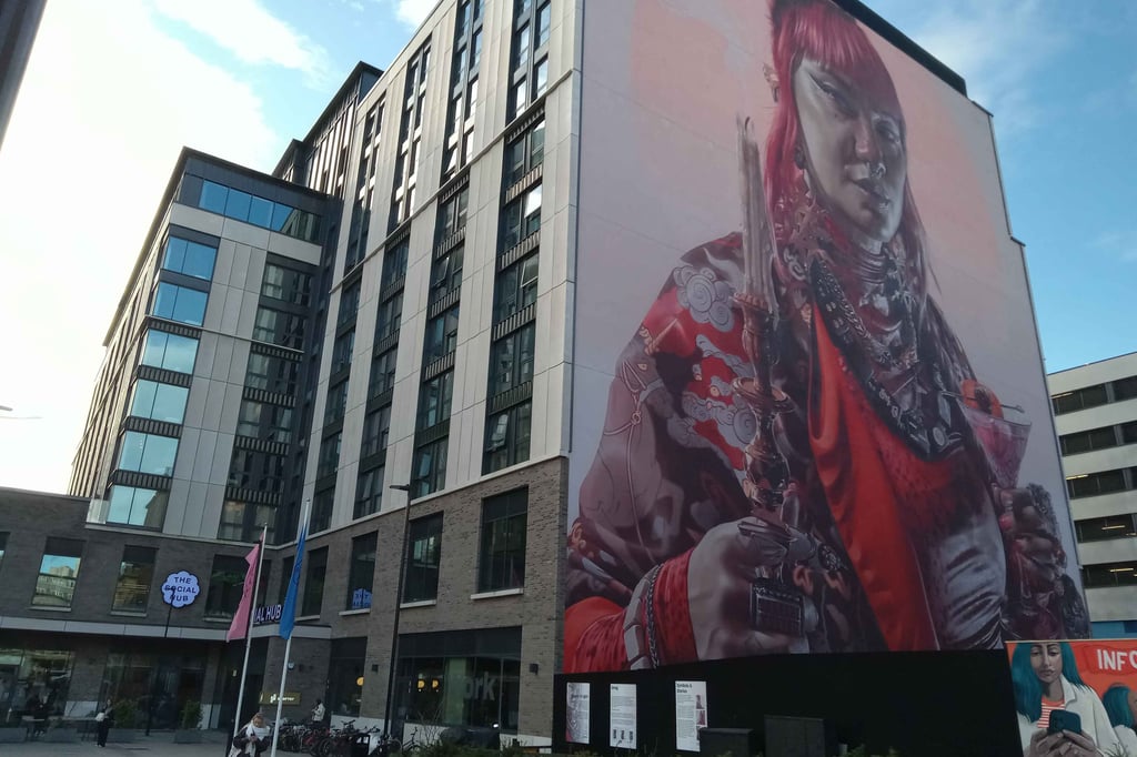 Keeper of Light mural of a nonbinary icon on the side of the Social Hub building