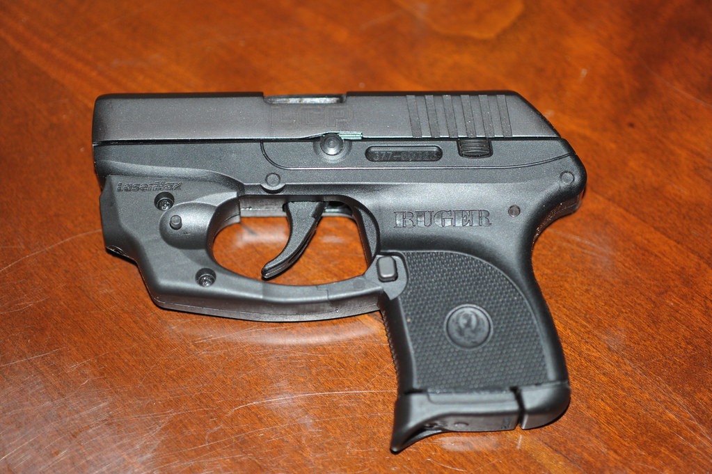 Ruger LCP with laser laying on a wood table
