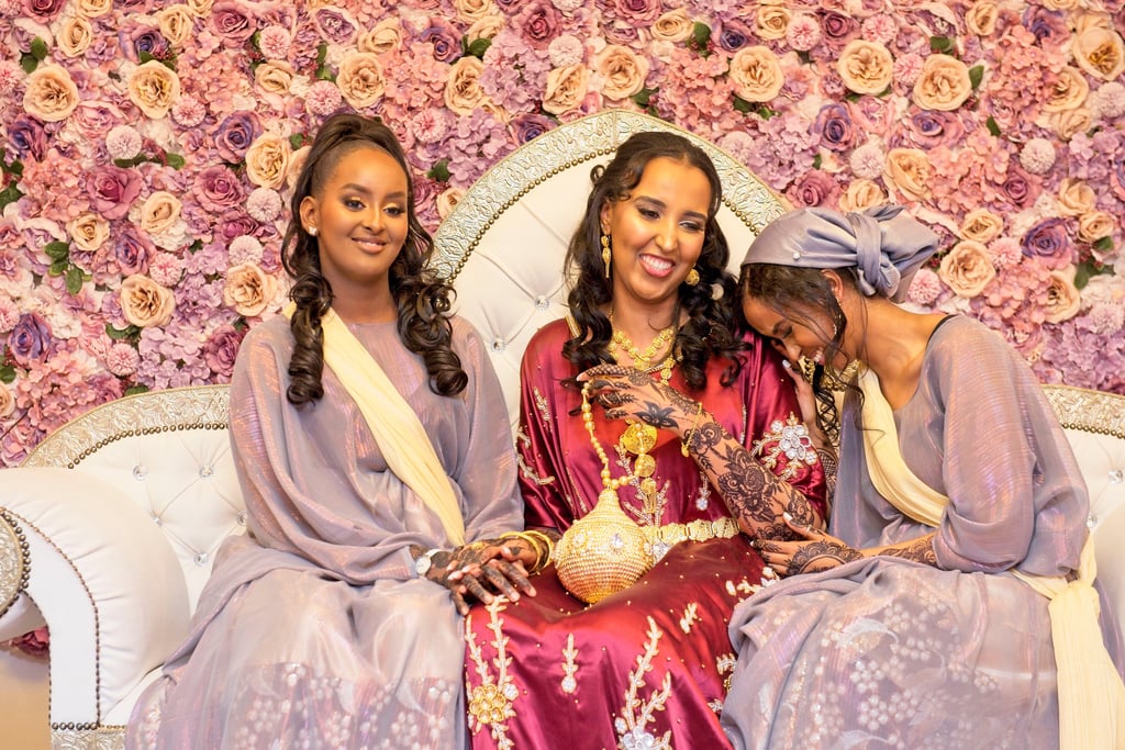 candid photo of Somalia n bridesmaid laughing and smiling with bride 