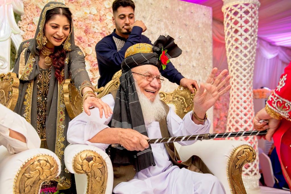 candid photo of bride's grandfather, he is laughing and smiling 