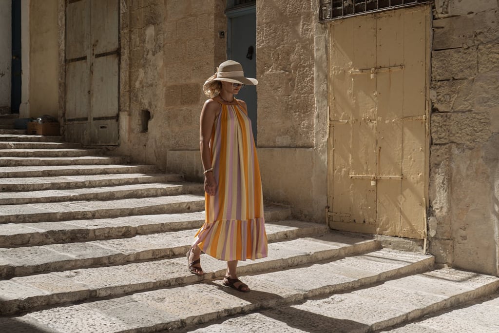 Solo female traveler walking through historic Valletta