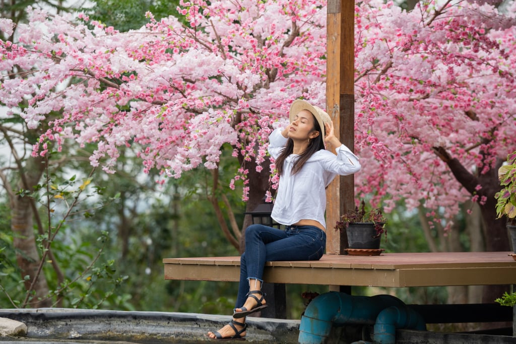 Solo traveler seated under torii gates in Kyoto