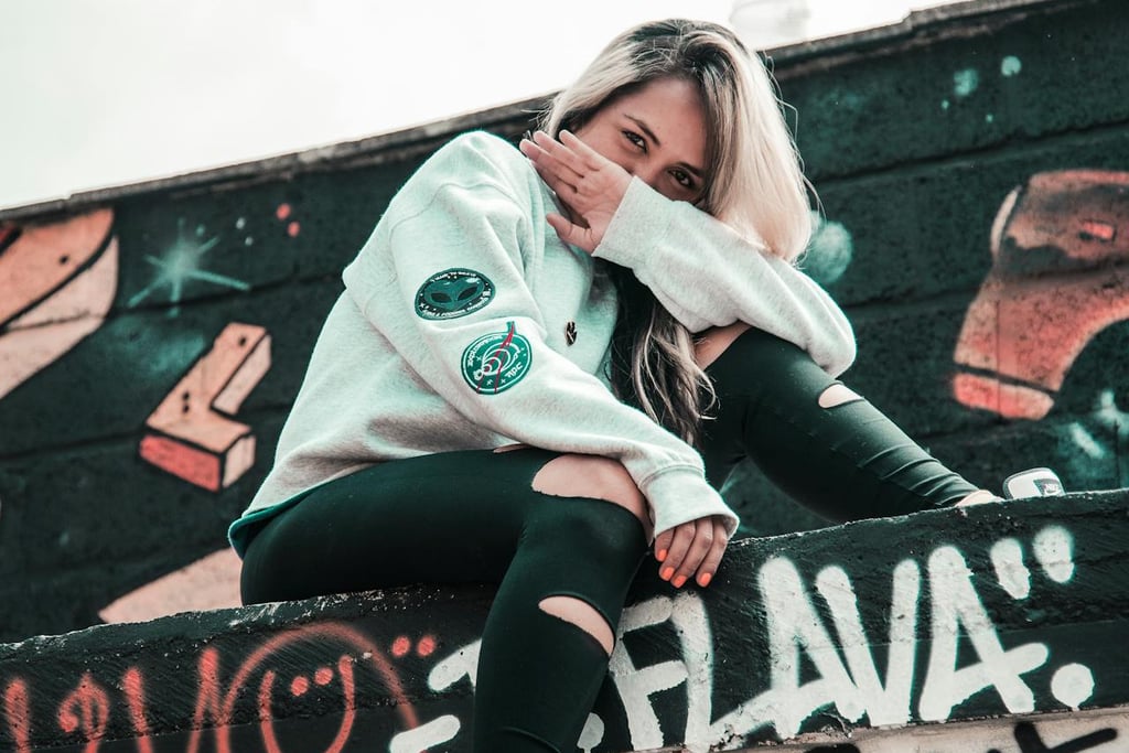 Solo traveler exploring sitting and surrounded by street art in Medellín, Colombia