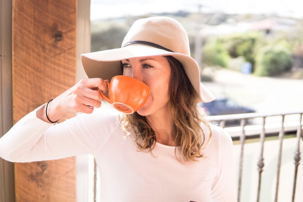 Female traveler enjoying coffee in Melbourne laneway café