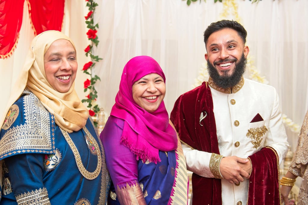 candid photo of groom with his mum and aunty, all laughing and smiling 