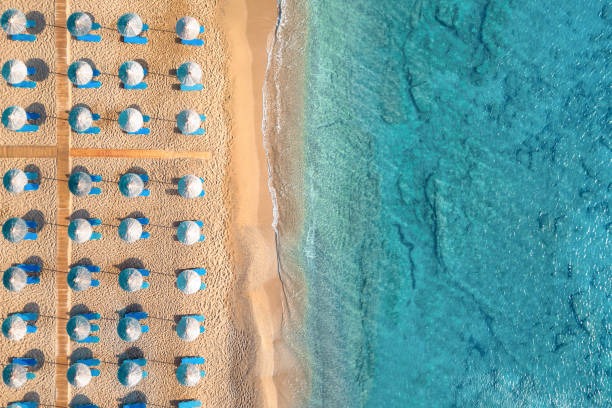 Aerial view of rows of beach umbrellas, Crete