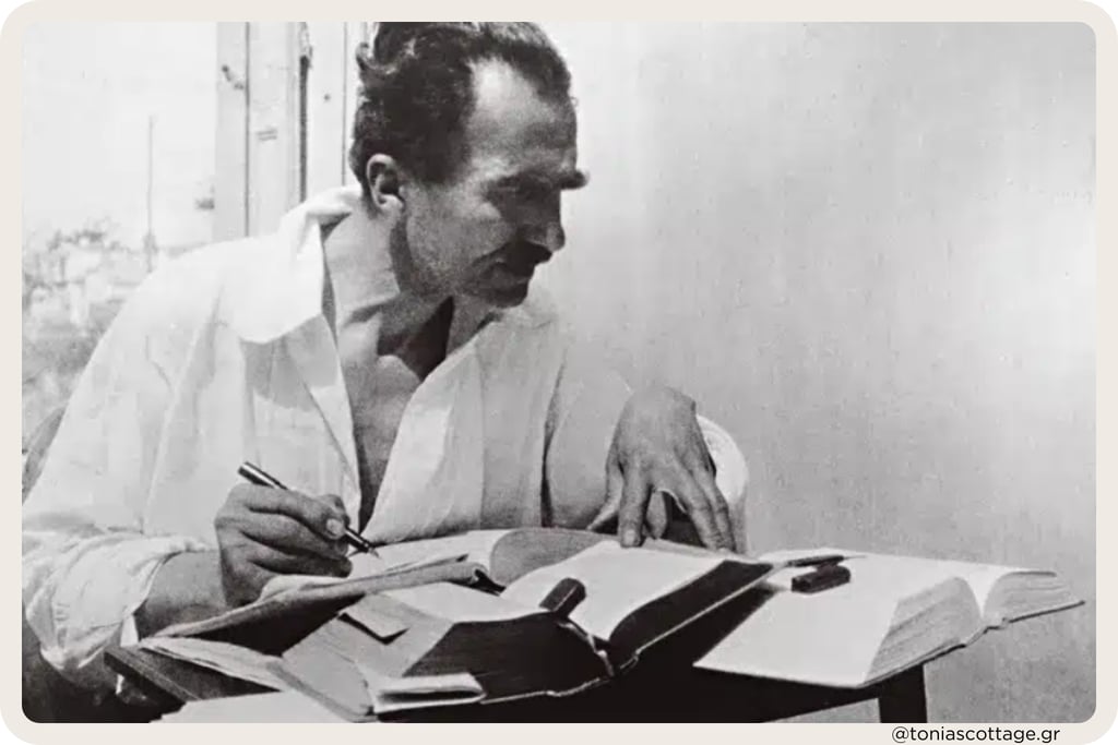 Black and white picture of Nikos Kazantzakis writing, capturing a moment of his creative proces