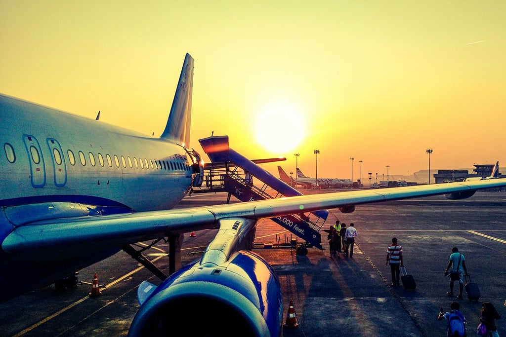 Jet airliner on runway with sunset background