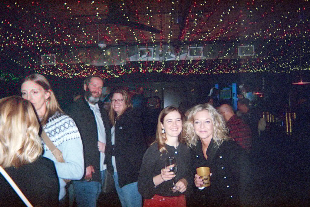 People posing with their drinks in a crowd