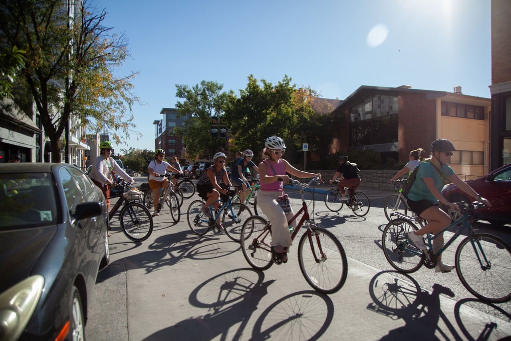 Group of women on bikes riding on a downtown street