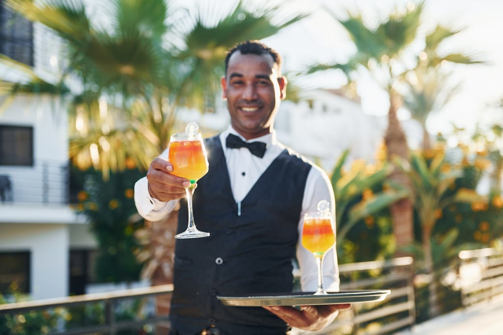Friendly resort staff serving cocktail at Dominican Republic all-inclusive