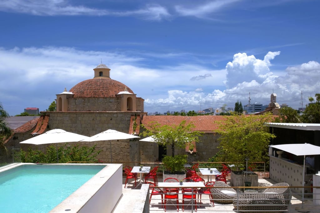 Rooftop pool in Santo Domingo Colonial Zone with historic church and city view