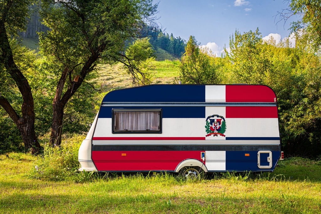 Camping in the Dominican Republic with a DR-flag camper in lush green nature