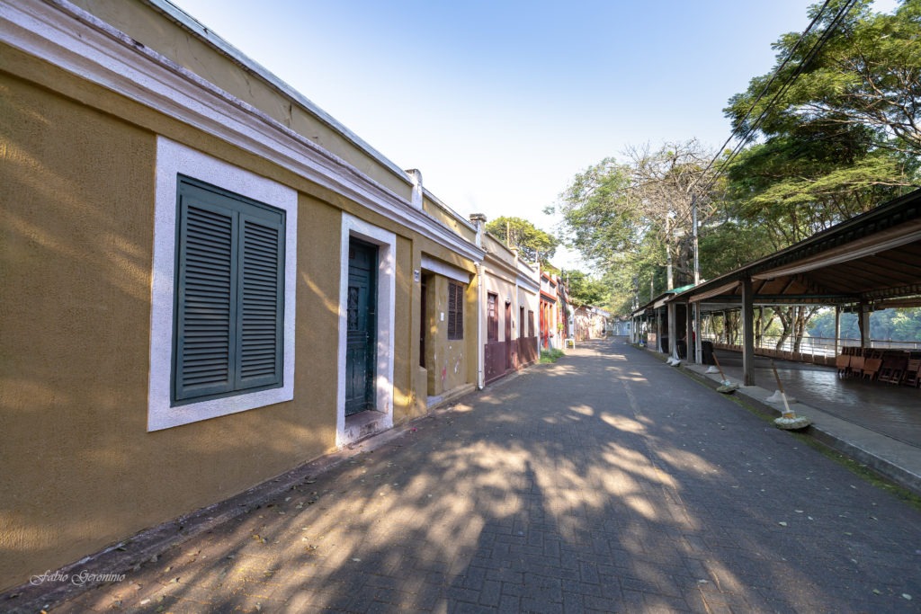 a street scene with a long narrow alley with a brick wall and a brick wall
