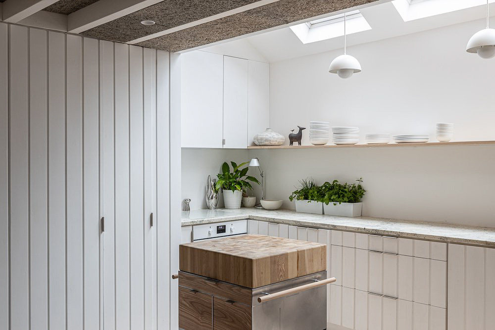 a kitchen with a wooden table and a dishwasher